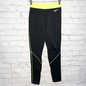 Nike Pro black leggings with neon yellow/green waistband and branding